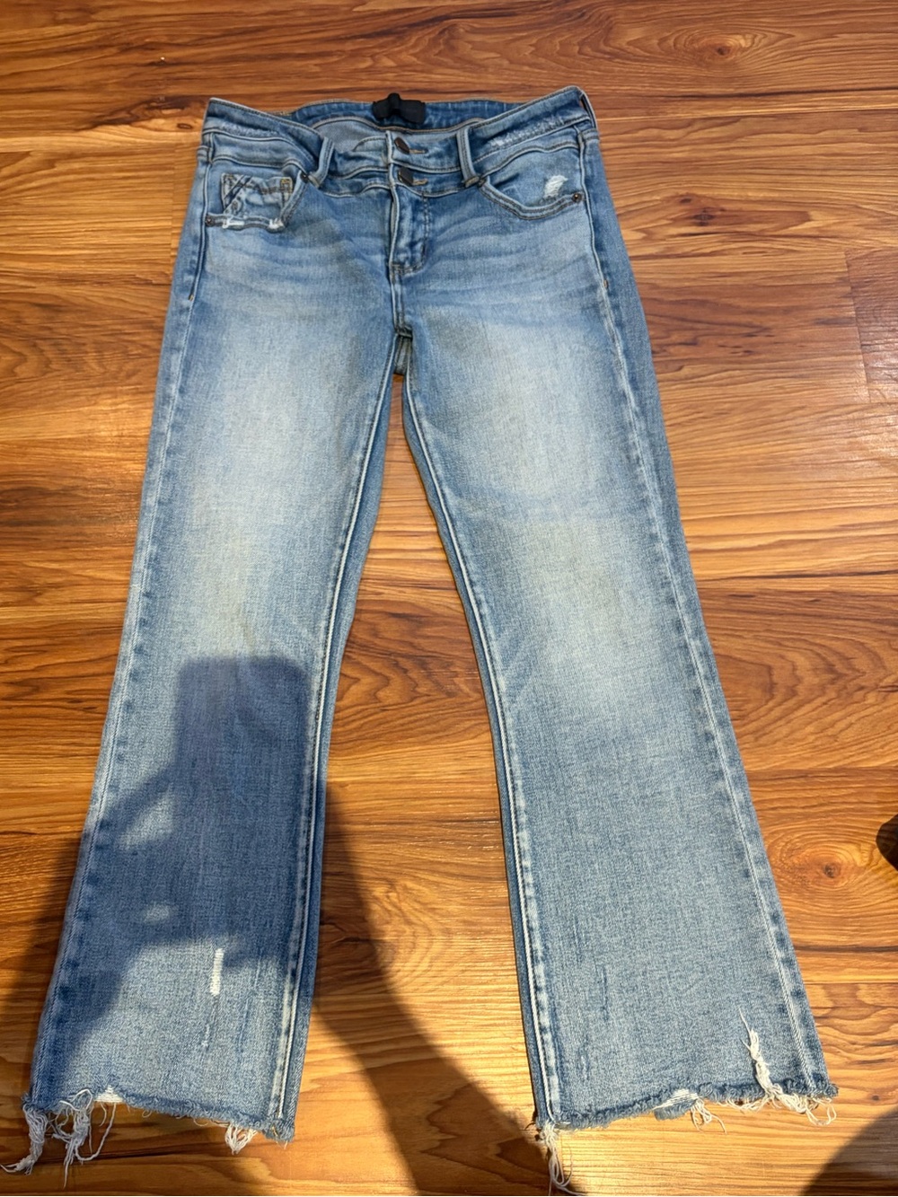 Buckle Light Blue Flare Jeans with Distressed Hem